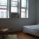 Bedroom with large windows and hardwood floors